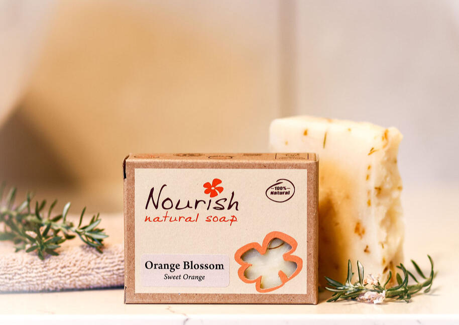 orange blossom handmade soap sitting on a cozy bathroom counter